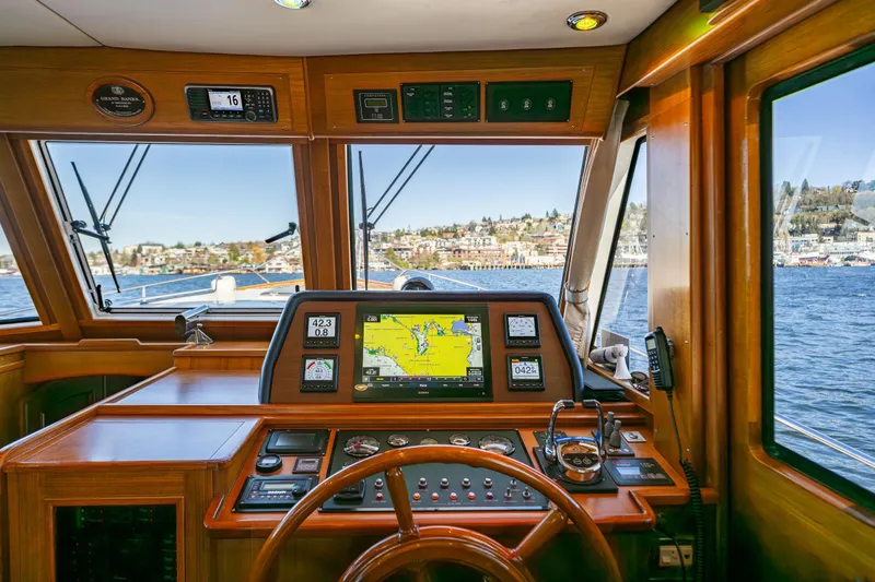 Slide: The Image of Helm of 2006 Grand Banks 47 Europa yacht with navigation equipment and scenic water view. - 39