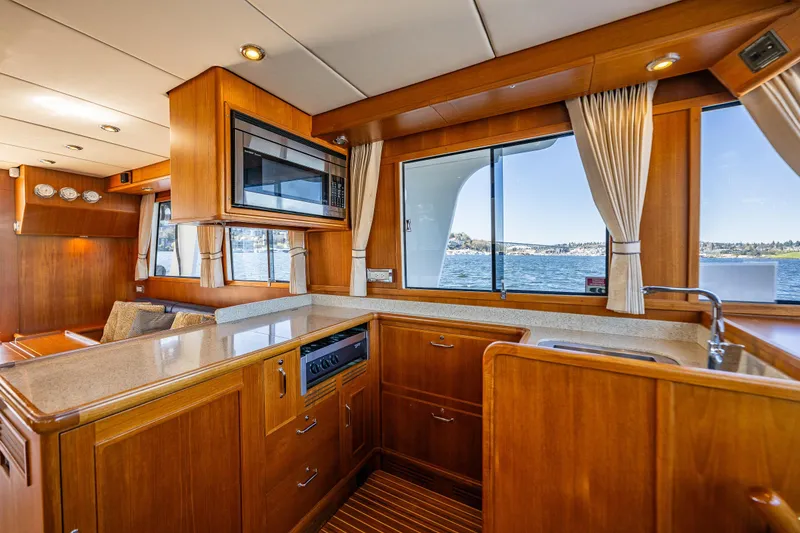 Slide: The Image of Luxurious 2006 Grand Banks 47 Europa yacht interior with elegant wood finishes and modern amenities. - 42