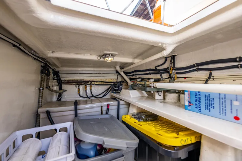 Slide: The Image of Storage compartment of 2006 Grand Banks 47 Europa yacht, featuring organized equipment and supplies. - 49