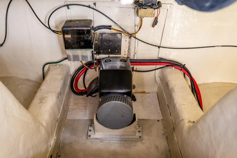 Slide: The Image of Engine compartment of a 2006 Grand Banks 47 Europa yacht, showcasing wiring and machinery. - 50