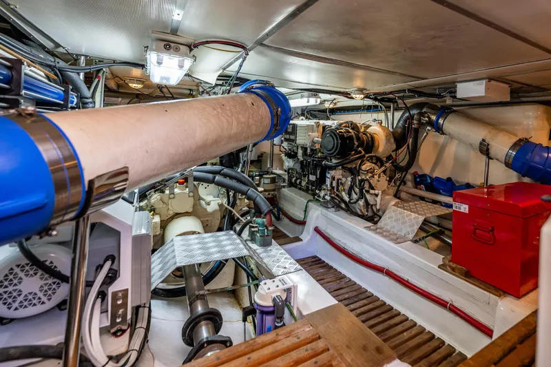 Slide: The Image of Engine room of 2006 Grand Banks 47 Europa yacht, showcasing mechanical components and equipment. - 51