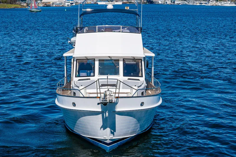 Slide: The Image of 2006 Grand Banks 47 Europa yacht on blue water, front view. - 6