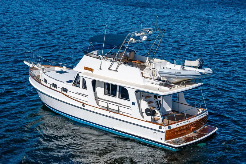 Slide: The Image of 2006 Grand Banks 47 Europa yacht cruising on blue ocean waters. - 7