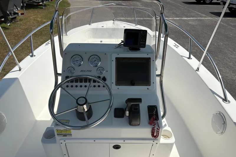 Slide: The Image of 2005 Sea Pro 190 Center Console boat dashboard with steering wheel and navigation instruments. - 14