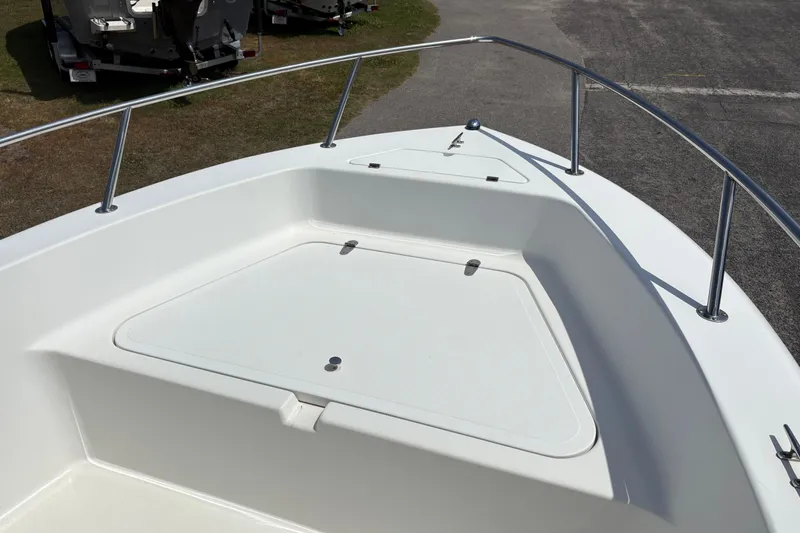 Slide: The Image of 2005 Sea Pro 190 Center Console boat deck with storage compartments and railing. - 19