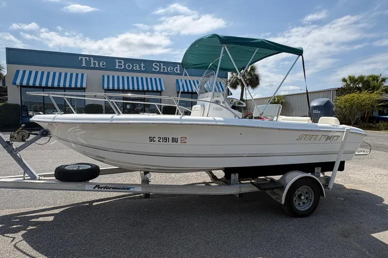 The Image of 2005 Sea Pro 190 Center Console boat on trailer, parked outside The Boat Shed. - 2