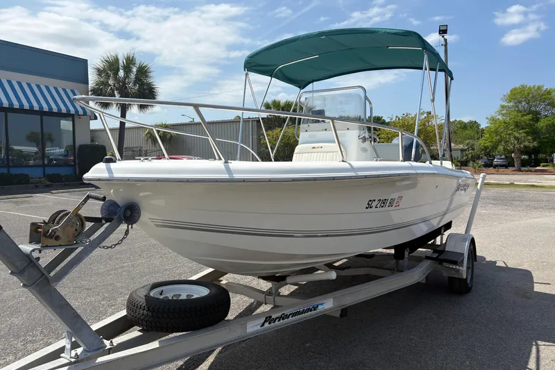 Slide: The Image of 2005 Sea Pro 190 Center Console boat on trailer, parked outdoors under blue sky. - 9