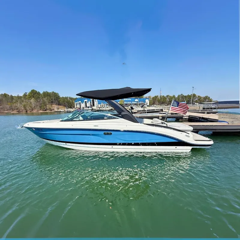 The Image of 2025 Sea Ray SLX 280 boat on water with American flag. - 0
