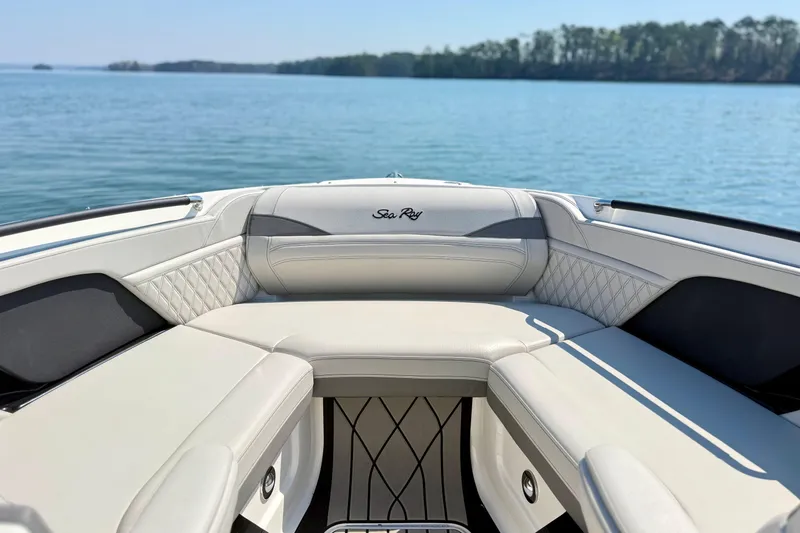 Slide: The Image of 2025 Sea Ray SLX 280 boat interior with luxurious seating on a serene lake. - 21