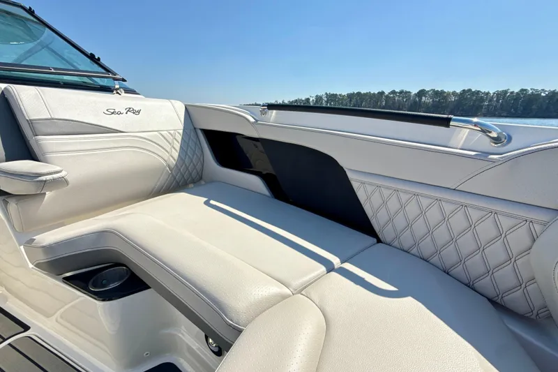 Slide: The Image of Luxurious seating on 2025 Sea Ray SLX 280 boat, featuring elegant white upholstery and scenic lake view. - 24