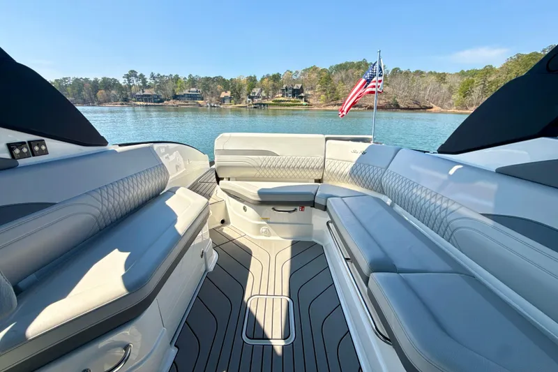 Slide: The Image of Luxurious 2025 Sea Ray SLX 280 boat interior with spacious seating and scenic lake view. - 26