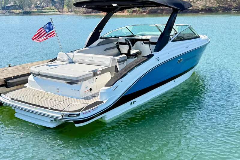 Slide: The Image of 2025 Sea Ray SLX 280 boat docked on clear water with American flag. - 4