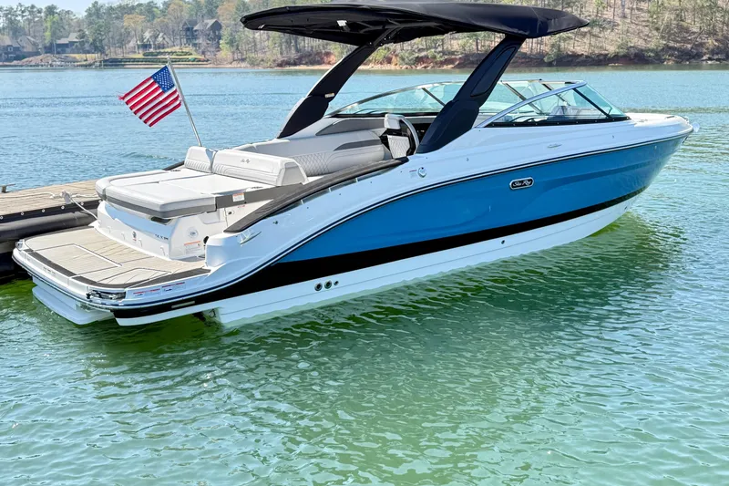 Slide: The Image of 2025 Sea Ray SLX 280 boat on calm water with US flag. - 5