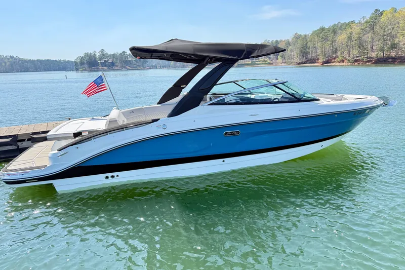 Slide: The Image of 2025 Sea Ray SLX 280 boat on a serene lake. - 6