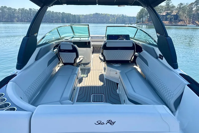 Slide: The Image of 2025 Sea Ray SLX 280 luxury boat interior with elegant seating and scenic lake view. - 9