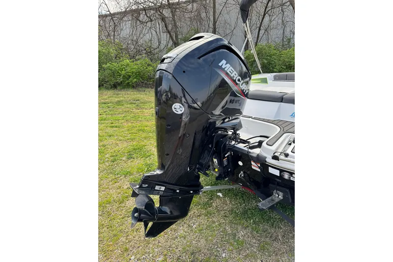 Slide: The Image of 2023 Tahoe T16 boat with Mercury outboard motor in grassy area. - 11