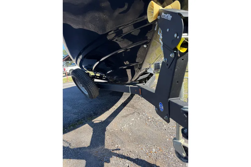 Slide: The Image of 2023 Tahoe T16 boat on trailer, close-up view of hull and wheel assembly. - 13