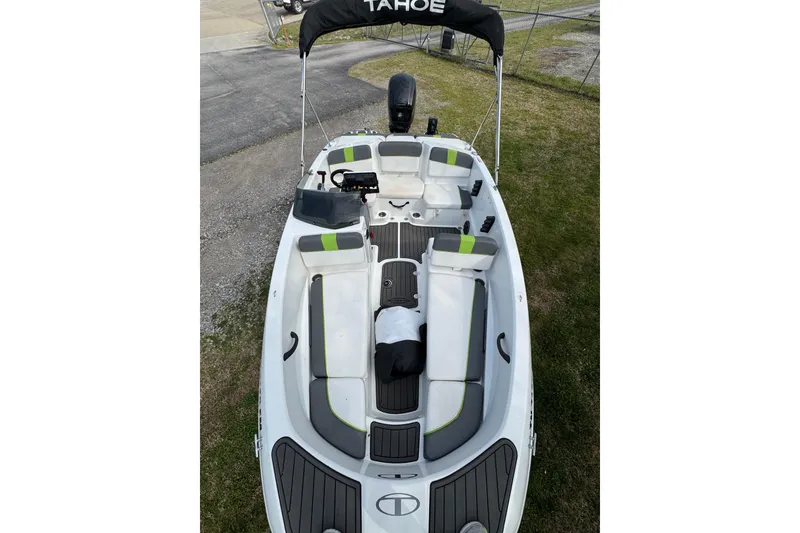 Slide: The Image of 2023 Tahoe T16 boat with seating and canopy, parked on grass. - 4
