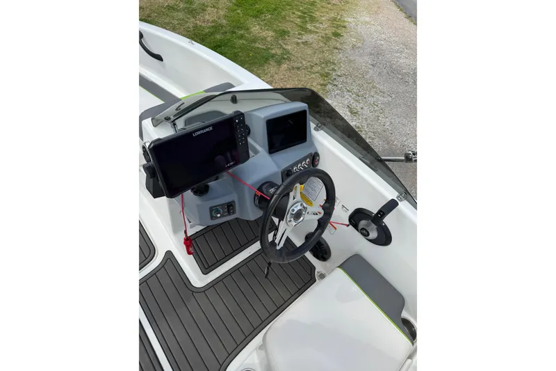 Slide: The Image of 2023 Tahoe T16 boat dashboard with steering wheel and navigation screens. - 5