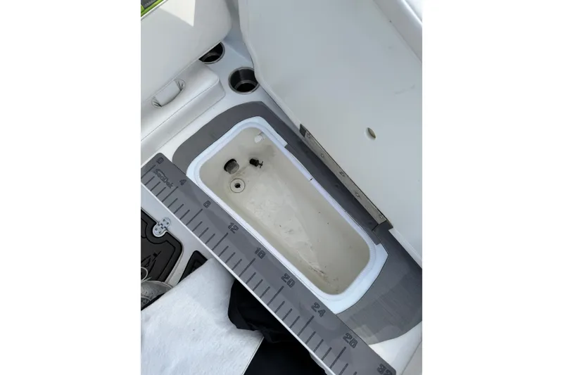 Slide: The Image of 2023 Tahoe T16 boat interior with built-in measuring ruler and storage compartment. - 7