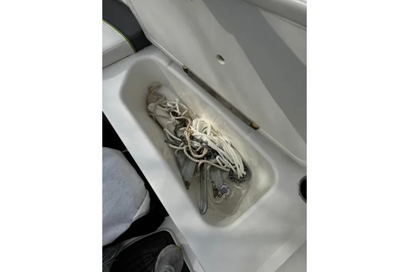 Slide: The Image of Storage compartment in 2023 Tahoe T16 boat with coiled rope inside. - 8