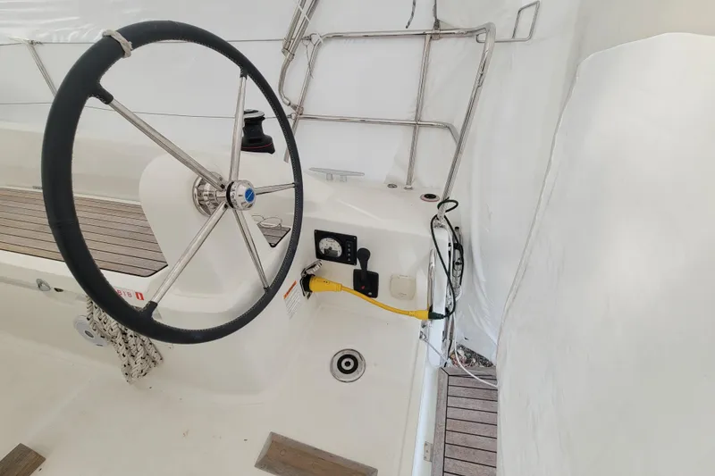 Slide: The Image of Steering wheel of a 2020 Beneteau Oceanis 30.1 sailboat, featuring modern controls. - 10