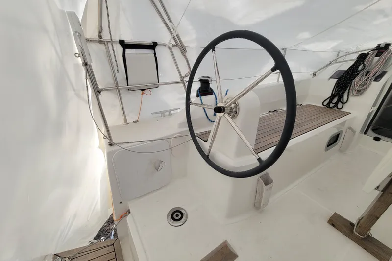 Slide: The Image of Cockpit of 2020 Beneteau Oceanis 30.1 sailboat with steering wheel and seating area. - 12