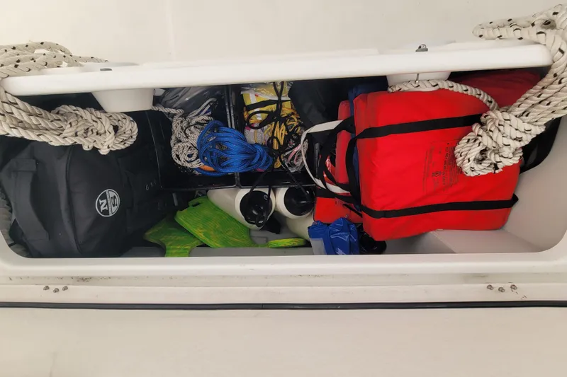 Slide: The Image of Storage compartment of 2020 Beneteau Oceanis 30.1 with ropes, life jacket, and gear. - 14