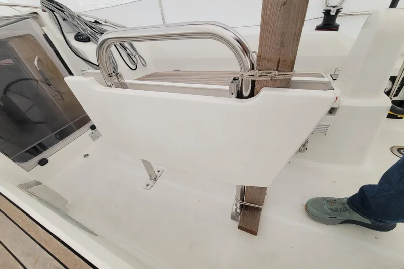 Slide: The Image of Beneteau Oceanis 30.1 yacht cockpit detail, featuring a foldable seat and stainless steel railing. - 16