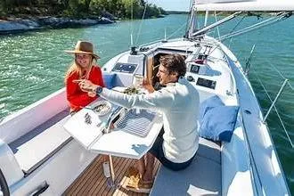 Slide: The Image of Couple enjoying a meal on a 2020 Beneteau Oceanis 30.1 sailboat. - 2