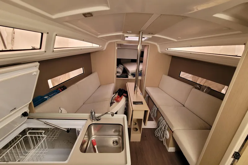Slide: The Image of Interior of 2020 Beneteau Oceanis 30.1 yacht with modern seating and kitchenette. - 27