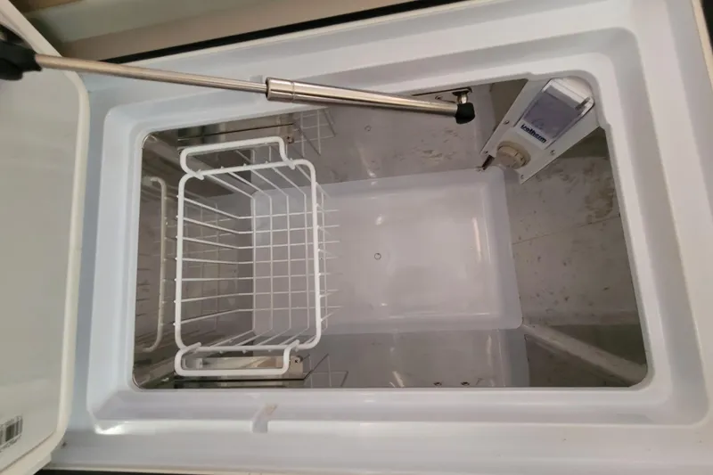 Slide: The Image of Open storage compartment in 2020 Beneteau Oceanis 30.1 yacht, featuring a wire basket. - 29