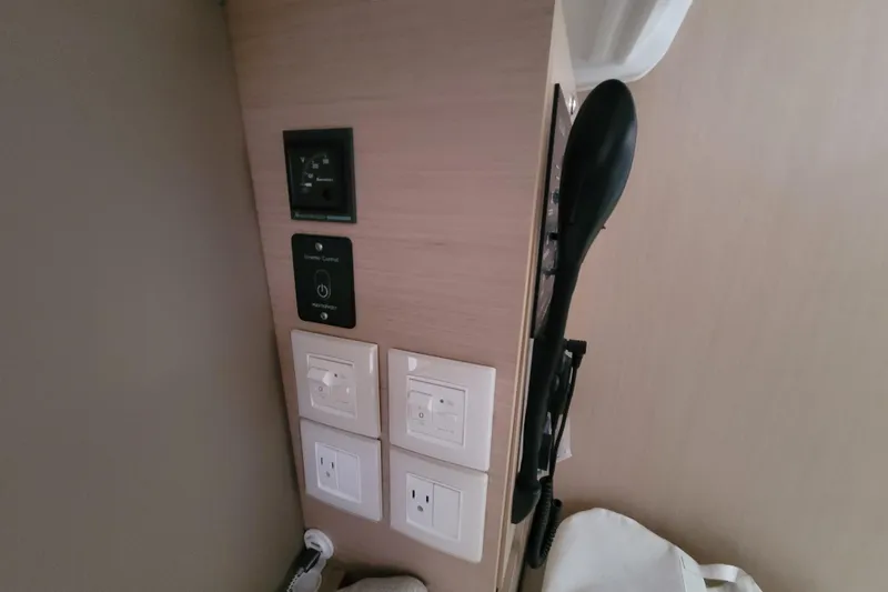 Slide: The Image of Control panel and outlets inside a 2020 Beneteau Oceanis 30.1 yacht cabin. - 32