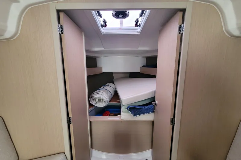 Slide: The Image of Interior cabin storage of 2020 Beneteau Oceanis 30.1 sailboat with shelves and cushions. - 33