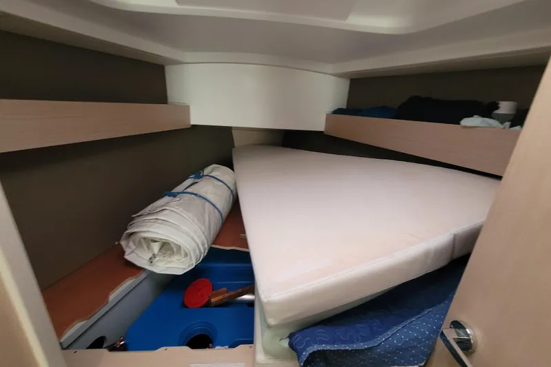 Slide: The Image of Interior cabin of 2020 Beneteau Oceanis 30.1 sailboat with storage and mattress. - 34