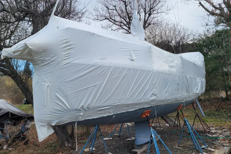 Slide: The Image of Beneteau Oceanis 30.1 sailboat, 2020 model, wrapped in protective covering, supported by stands. - 4