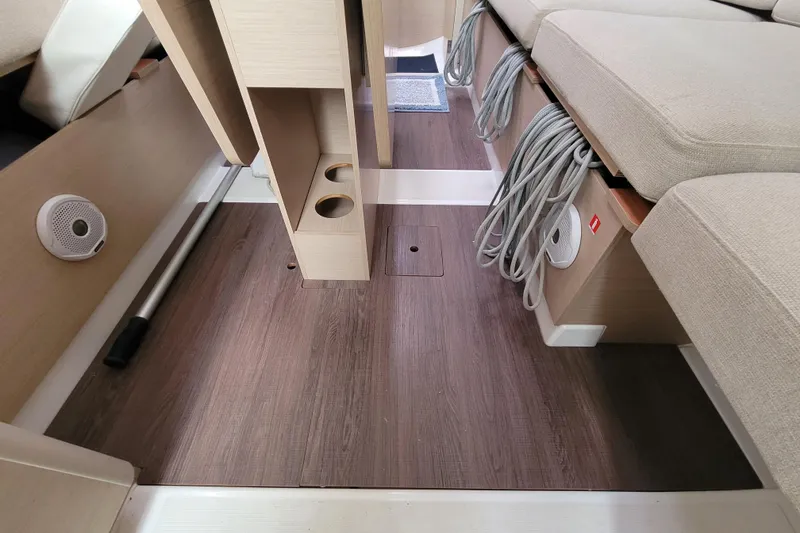 Slide: The Image of Interior of 2020 Beneteau Oceanis 30.1 sailboat, featuring wood flooring and seating. - 45