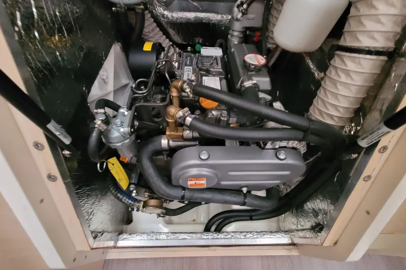 Slide: The Image of Engine compartment of a 2020 Beneteau Oceanis 30.1 sailboat, showcasing mechanical components. - 51