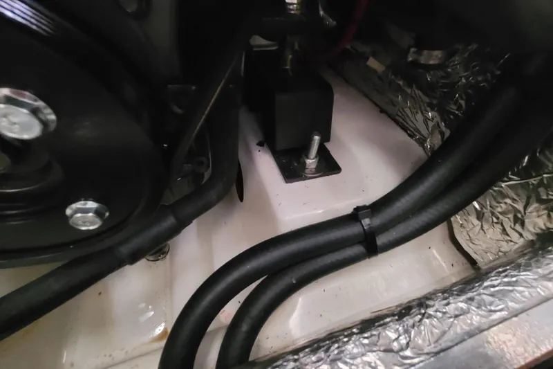 Slide: The Image of Engine compartment of a 2020 Beneteau Oceanis 30.1 sailboat, showing mechanical components. - 52