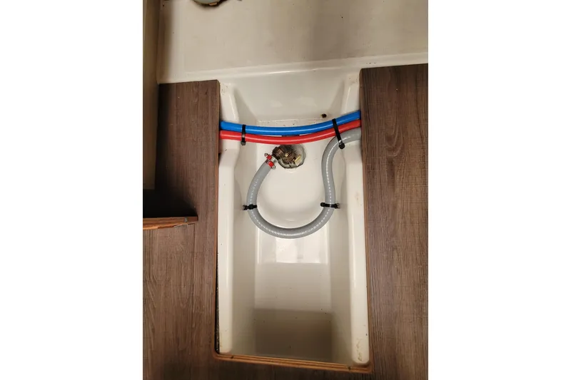 Slide: The Image of Beneteau Oceanis 30.1 (2020) interior plumbing with red and blue pipes. - 53