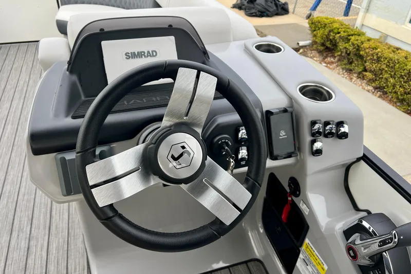Slide: The Image of Steering wheel and dashboard of a 2025 Harris Sunliner 230. - 13