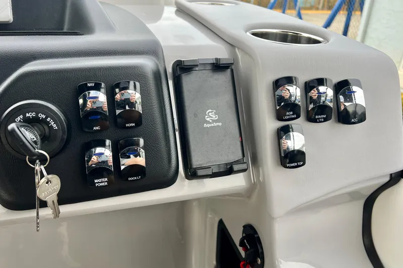Slide: The Image of Dashboard of Harris Sunliner 230 boat, 2025 model, featuring switches and ignition key. - 14