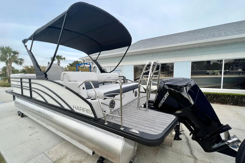 Slide: The Image of 2025 Harris Sunliner 230 pontoon boat with Mercury engine, side view. - 5