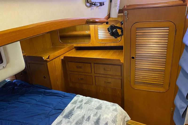 Slide: The Image of Interior of a 1988 Hylas 42 yacht featuring a well-equipped kitchen and cozy seating area. - 10