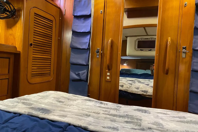 Slide: The Image of Cozy wooden cabin interior of a 1988 Hylas 42 yacht with storage and bedding. - 13