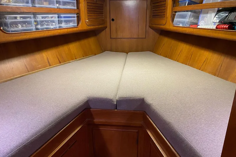 Slide: The Image of Cozy wooden cabin interior of a 1988 Hylas 42 yacht, featuring storage and a desk area. - 15