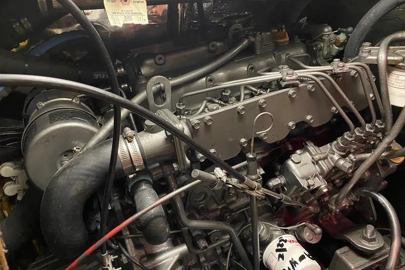 Slide: The Image of Engine compartment of a 1988 Hylas 42 sailboat, featuring a Yanmar engine. - 23