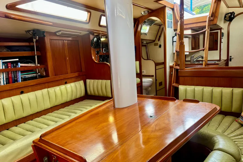 Slide: The Image of Interior of a 1988 Hylas 42 sailboat featuring wood finishes and compact design. - 5