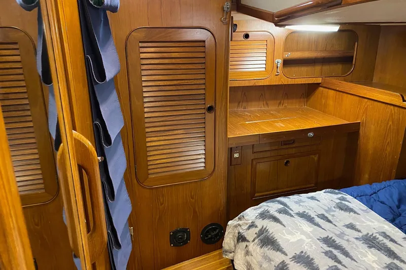 Slide: The Image of Interior of a 1988 Hylas 42 yacht with wood finishes and cushioned seating. - 9