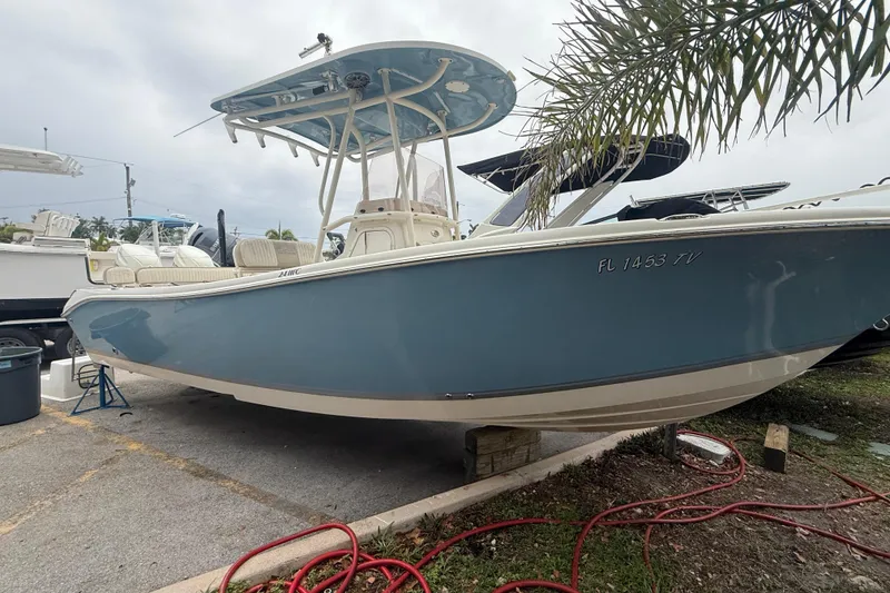 The Image of 2017 Sea Chaser 24 HFC boat in a marina, featuring a sleek blue hull. - 1